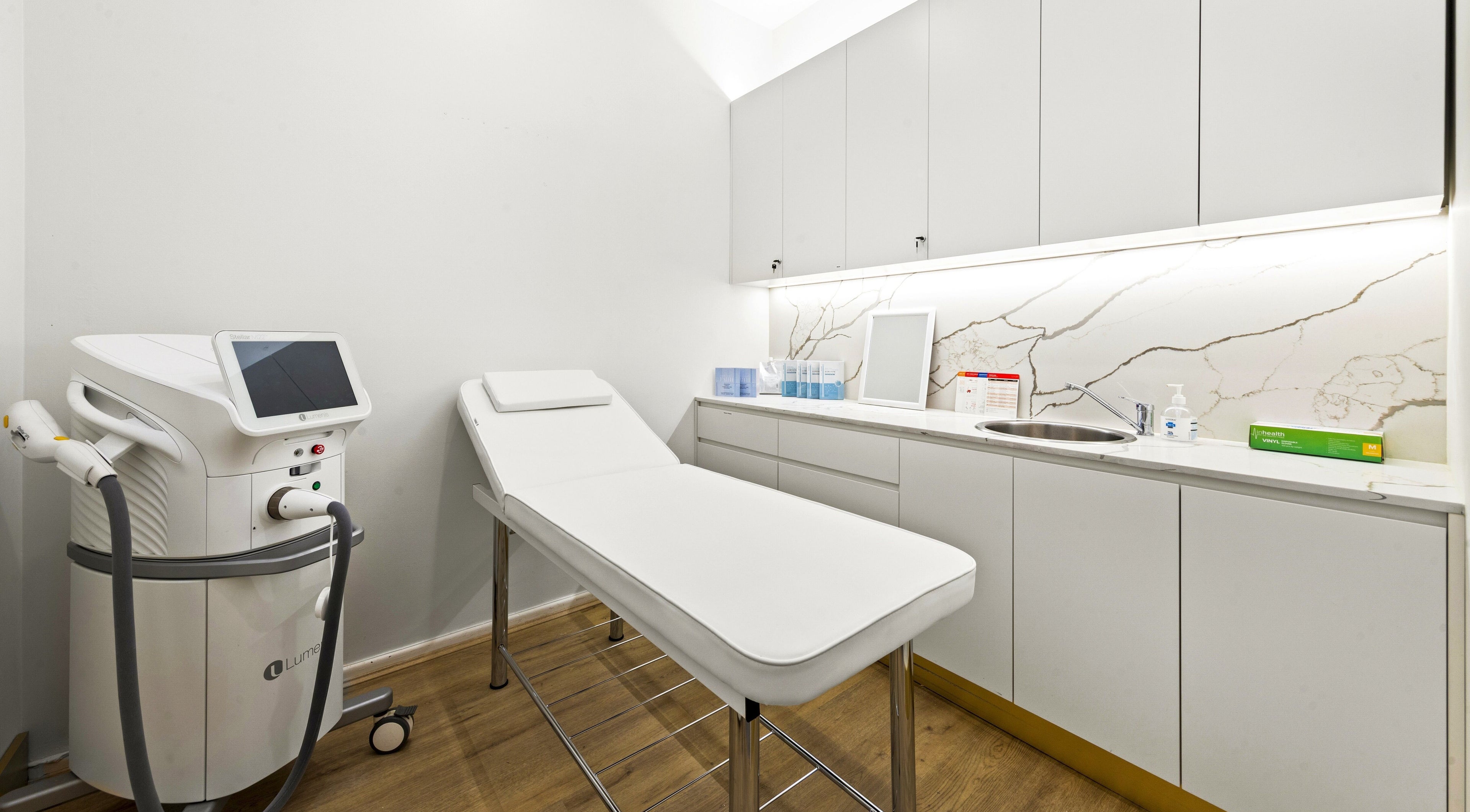 Modern treatment room at Lueur Clinic, North Willoughby, New South Wales, AU with sleek cabinetry and equipment.