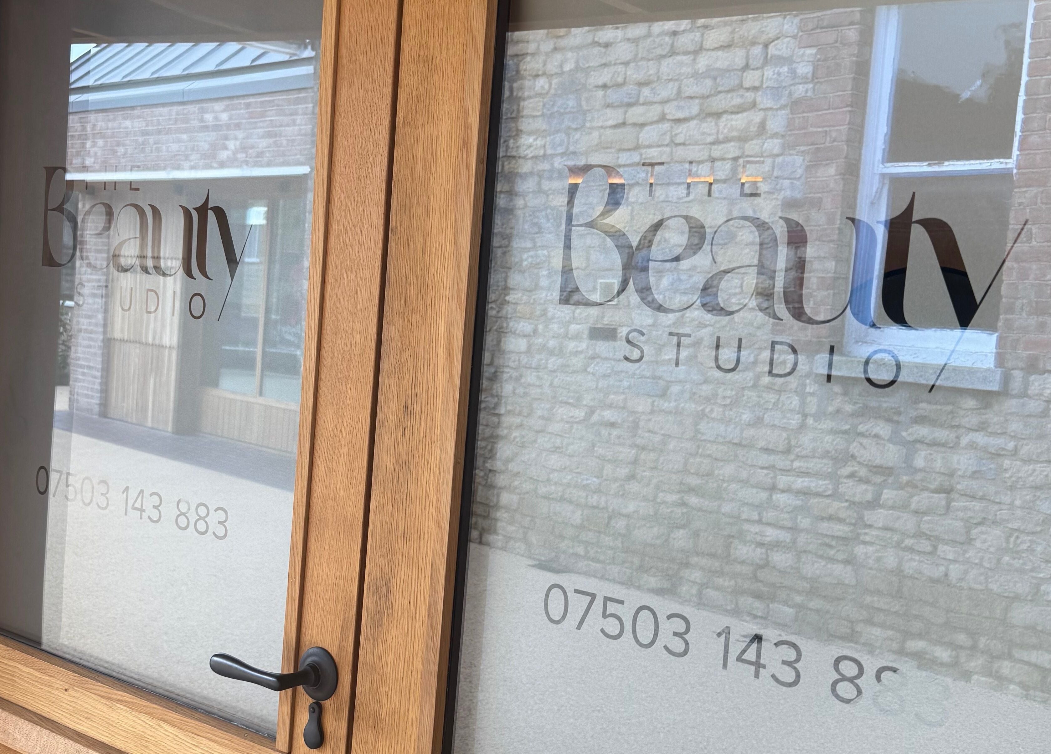 Glass door of The Beauty Studio in Peterborough, England, GB with stylish logo.