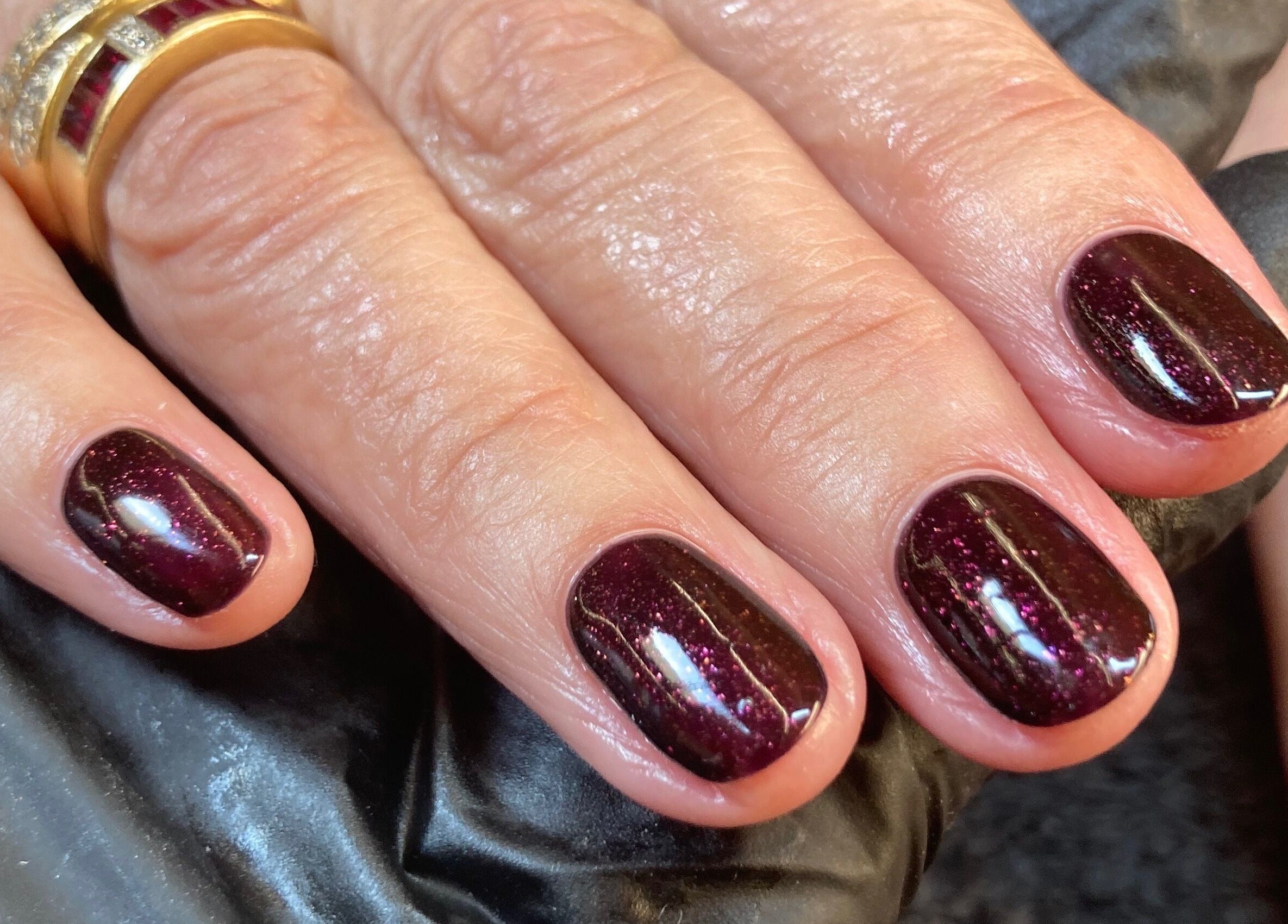 Glittering dark red manicure at The Beauty Studio, Peterborough, England, GB.