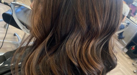 Elegant wavy hairstyle at Hair By Rose in Worthing, England, GB, showcasing rich brown highlights.