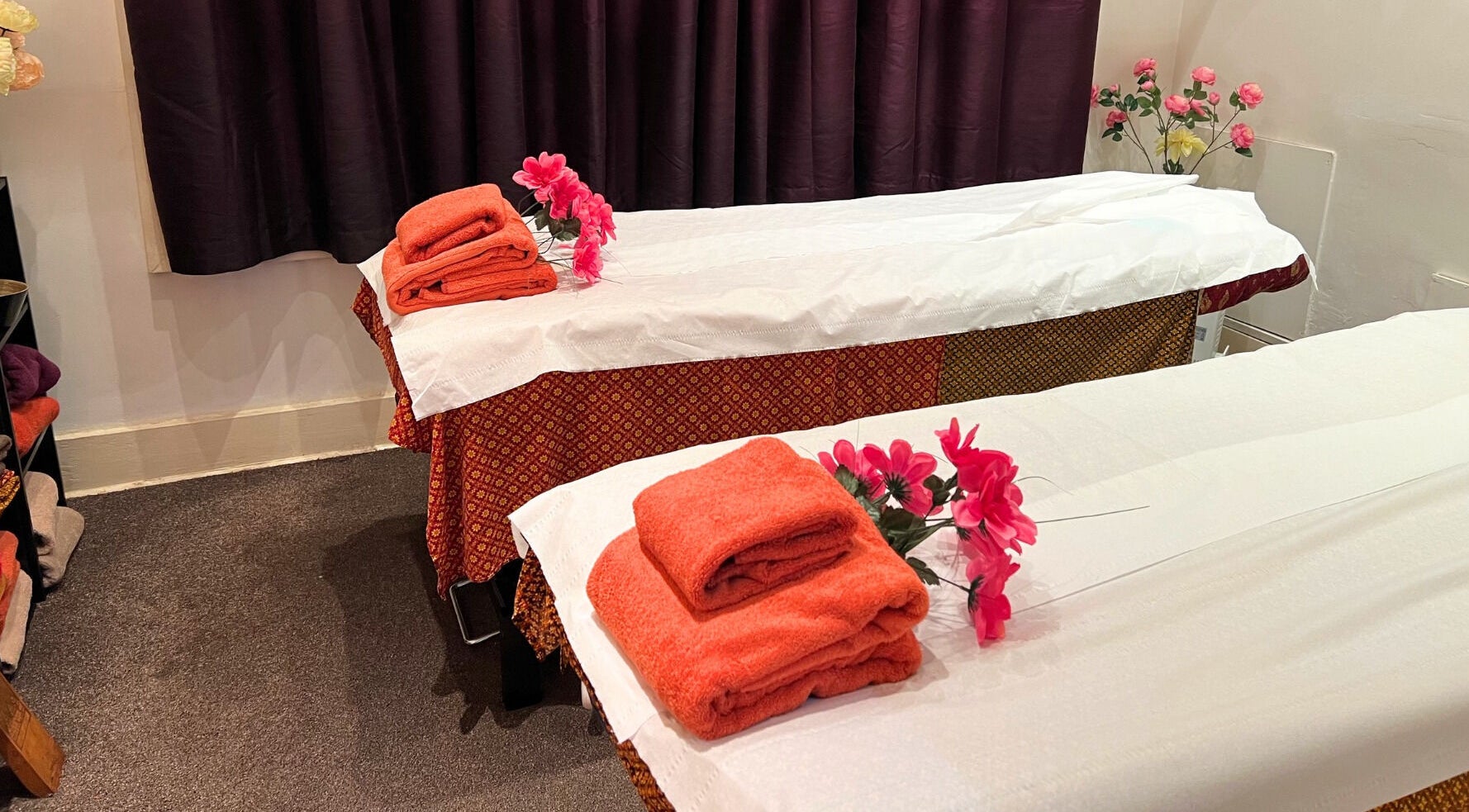 Relaxing treatment room at Khun Nine Thai Spa in Fulham, London, England, GB with decorated massage tables.