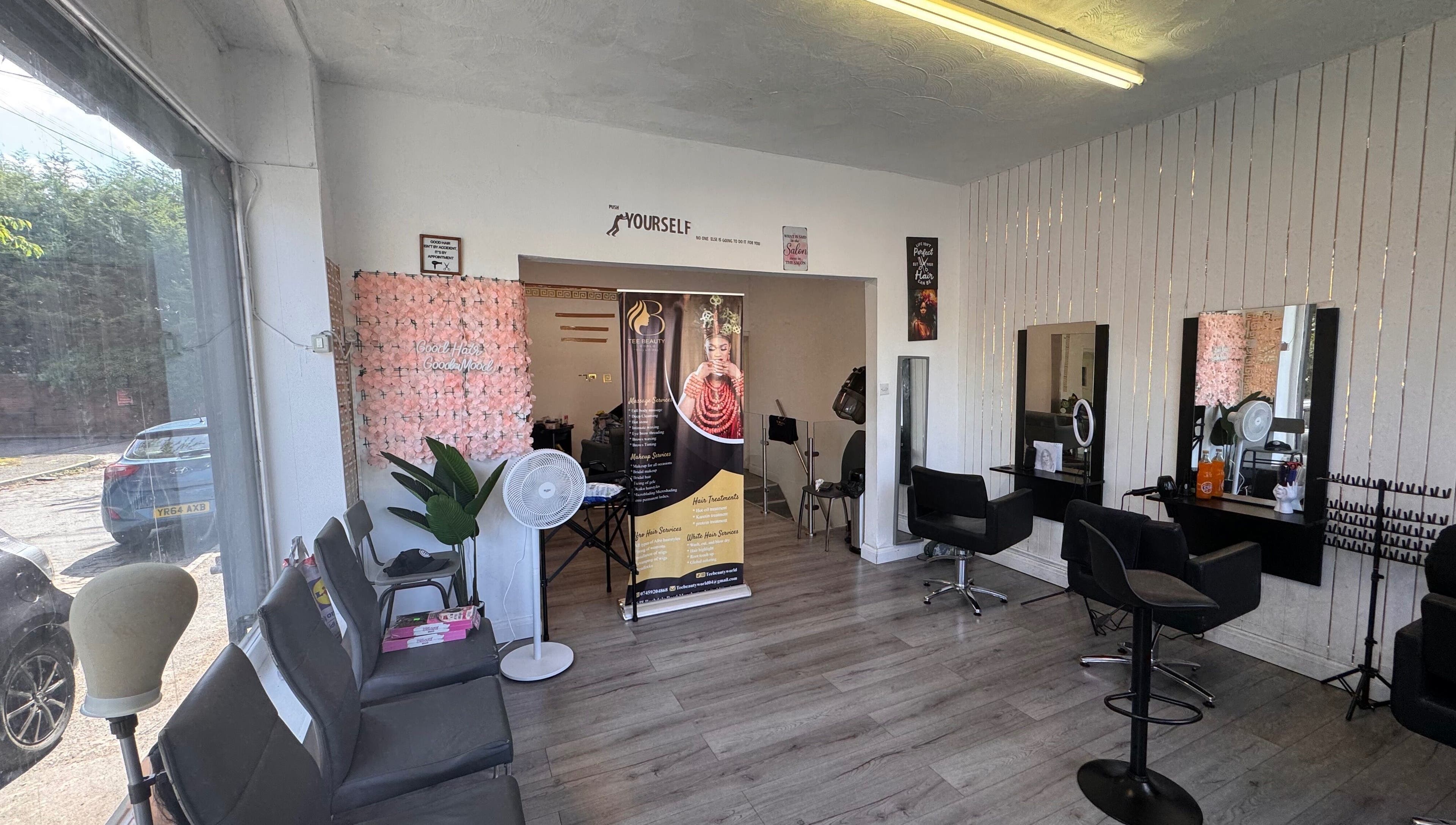 Interior of TeeBeauty World in Manchester, England, GB, showcasing stylish salon seating and wall decor.