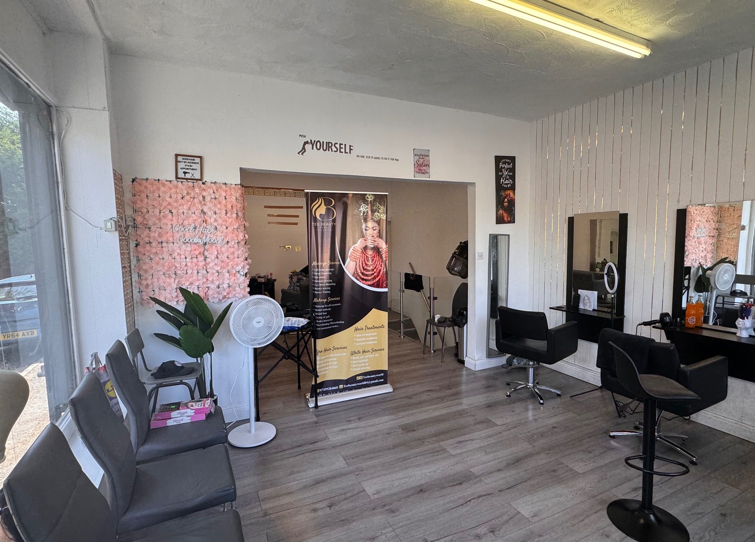 Interior of TeeBeauty World in Manchester, England, GB, showcasing stylish salon seating and wall decor.