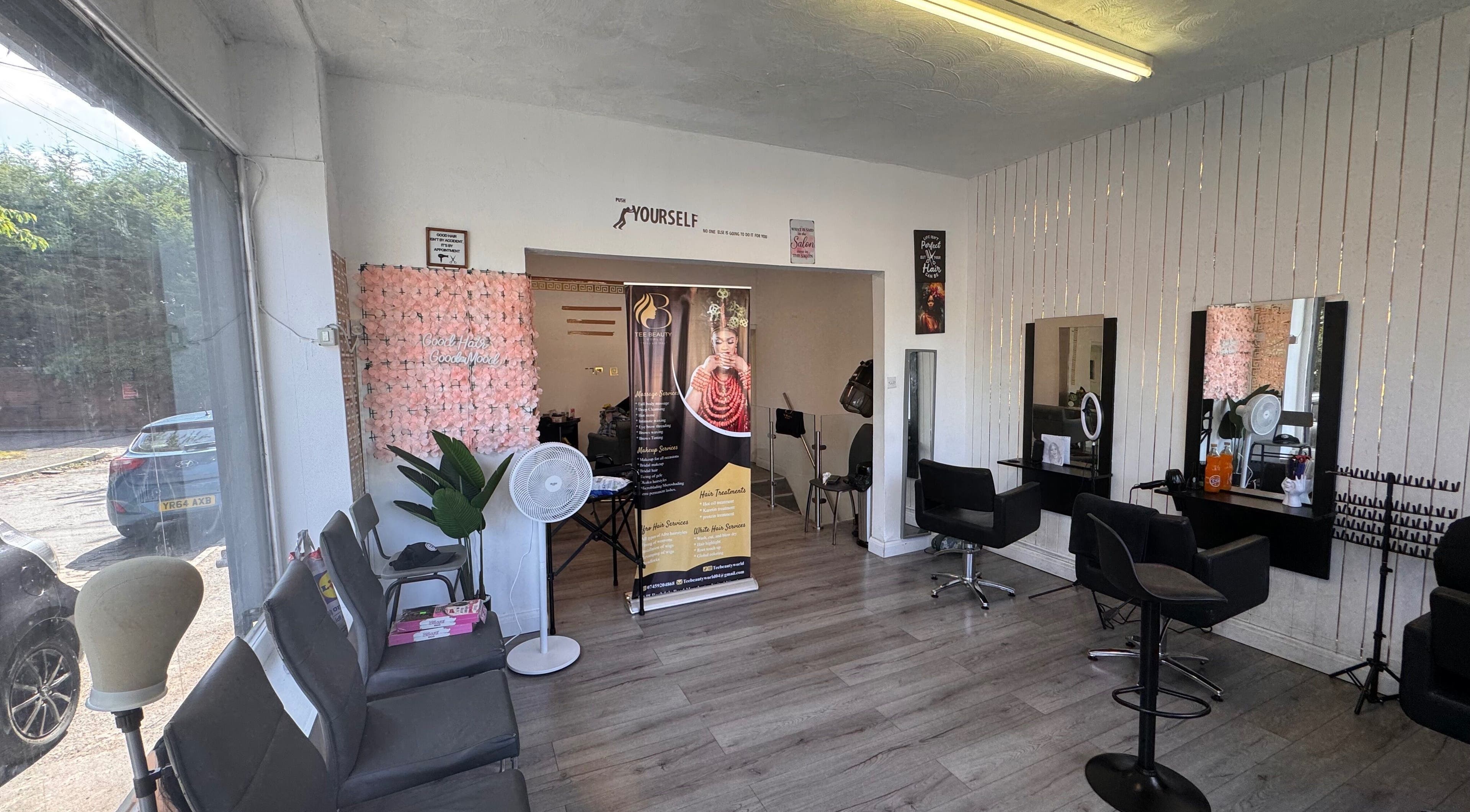 Interior of TeeBeauty World in Manchester, England, GB, showcasing stylish salon seating and wall decor.