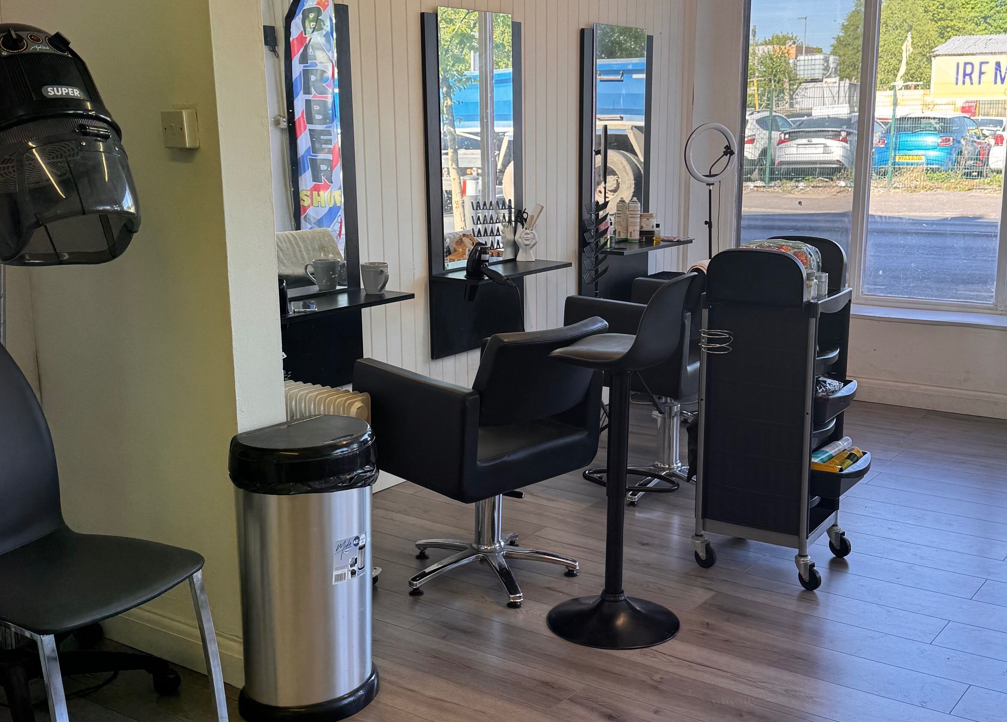 Sleek salon interior at TeeBeauty World in Manchester, England, GB with modern chairs and stylist stations.