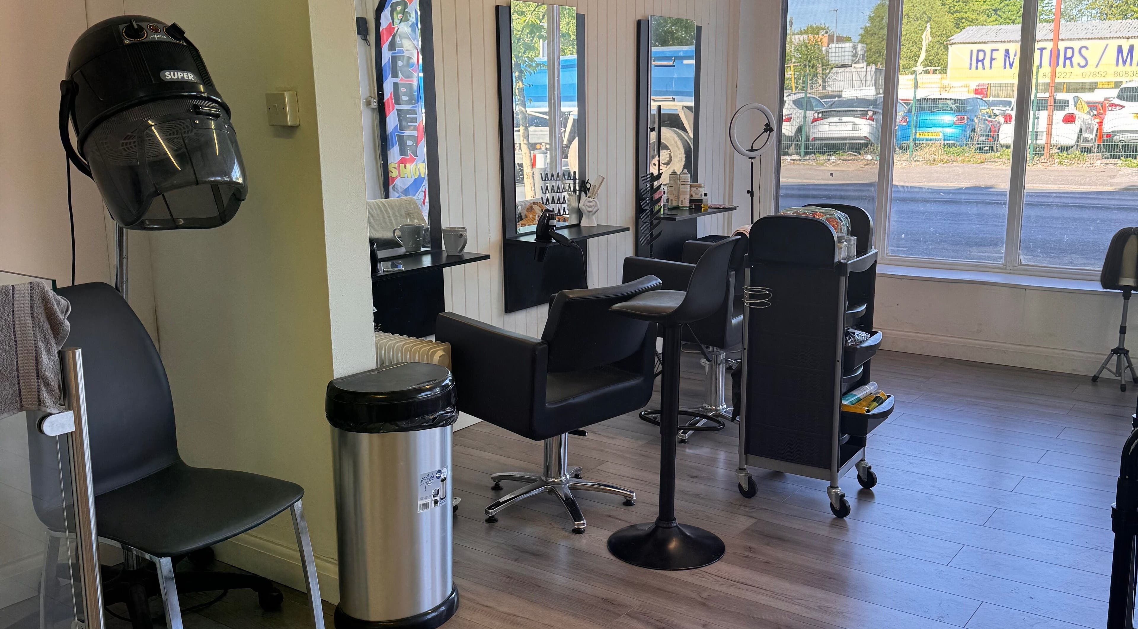 Sleek salon interior at TeeBeauty World in Manchester, England, GB with modern chairs and stylist stations.