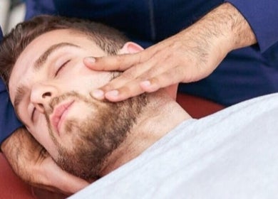 Man receiving a facial massage at Elite Therapy, Luton, England, GB.
