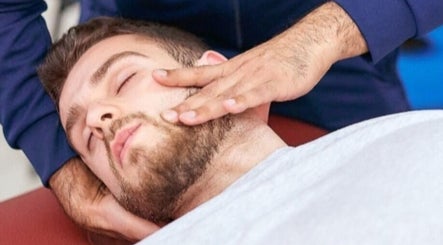 Man receiving a facial massage at Elite Therapy, Luton, England, GB.