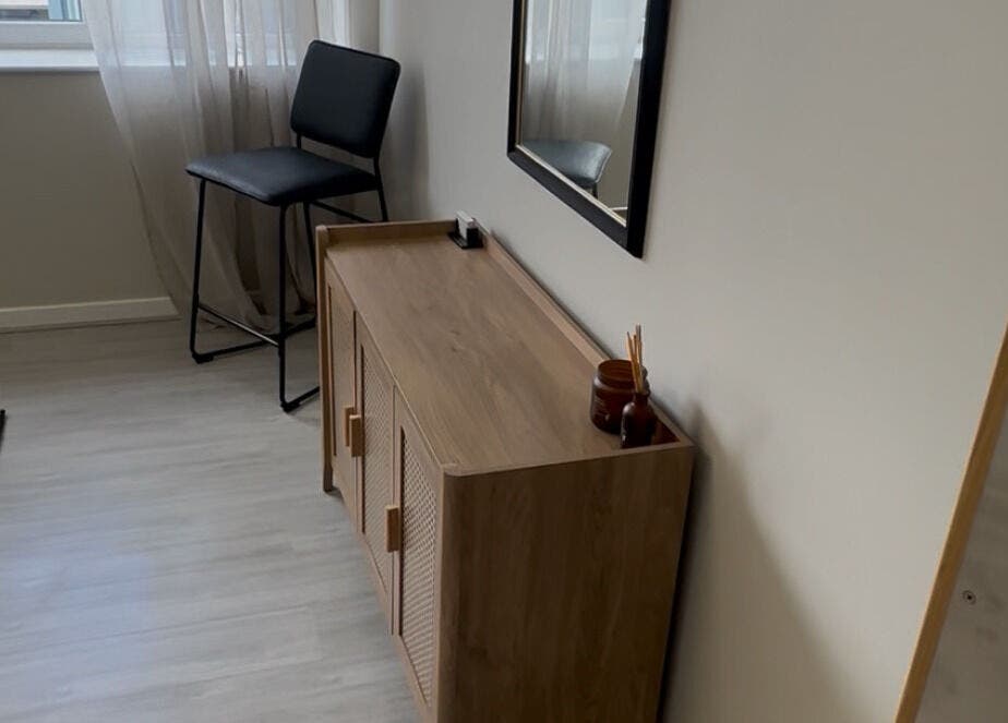 Chic waiting area at Hidden Beauty in Stornoway, Scotland, GB with modern decor and a cozy chair.