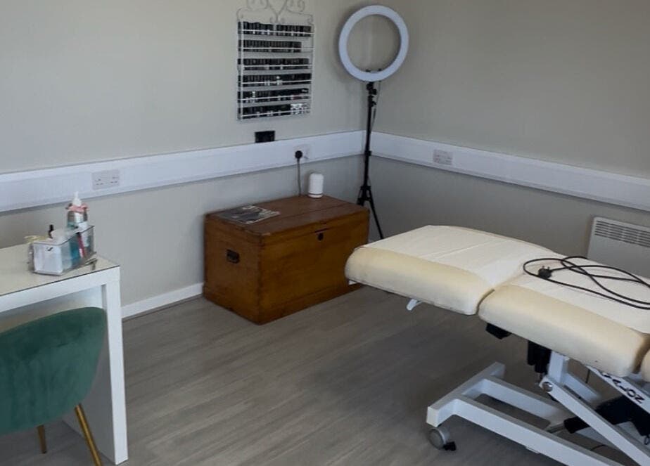 Serene treatment room at Hidden Beauty, Stornoway, Scotland, GB with a massage bed and cozy decor.