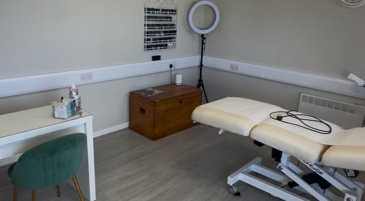 Serene treatment room at Hidden Beauty, Stornoway, Scotland, GB with a massage bed and cozy decor.