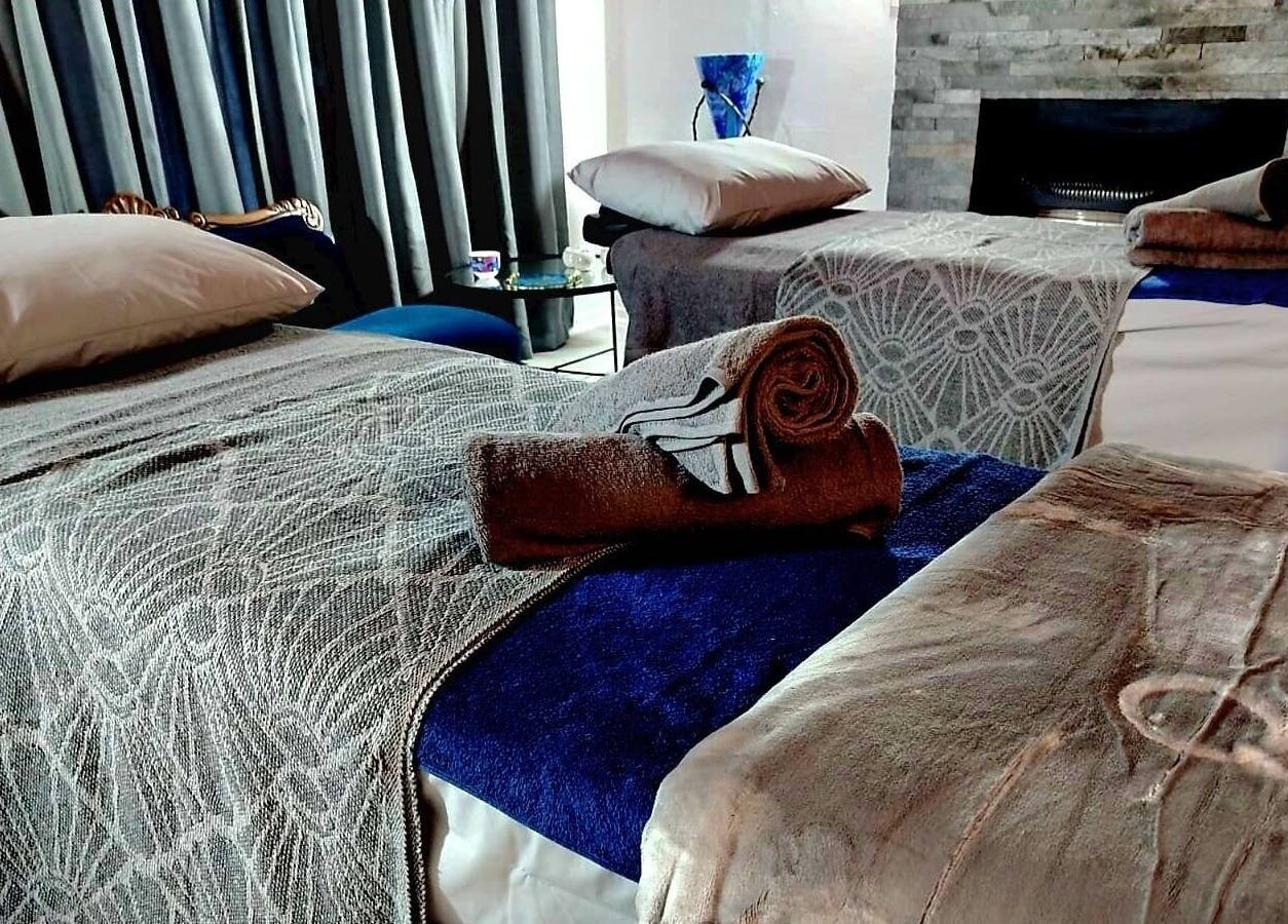 Tranquil massage beds at Relax Greyton Spa, Greyton, Western Cape, ZA, with plush towels and soothing decor.