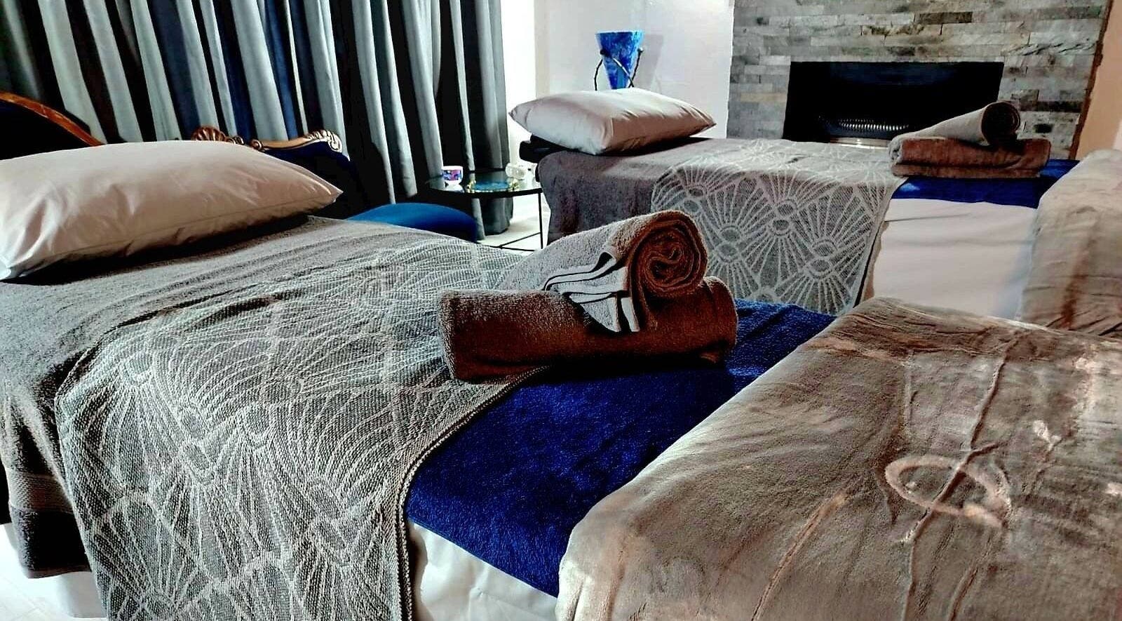 Tranquil massage beds at Relax Greyton Spa, Greyton, Western Cape, ZA, with plush towels and soothing decor.