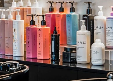 Variety of hair care products at Repose Ladies Salon L.L.C, Dubai, Dubai, AE displayed neatly on a shelf.