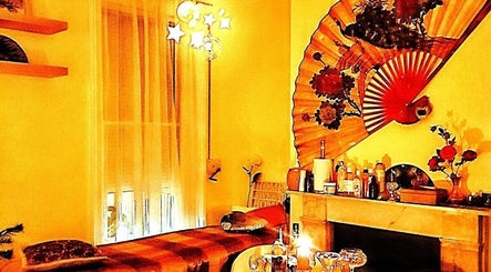 Relaxing massage room at Doctor Massage, London, England, GB with cozy decor and ambient lighting.