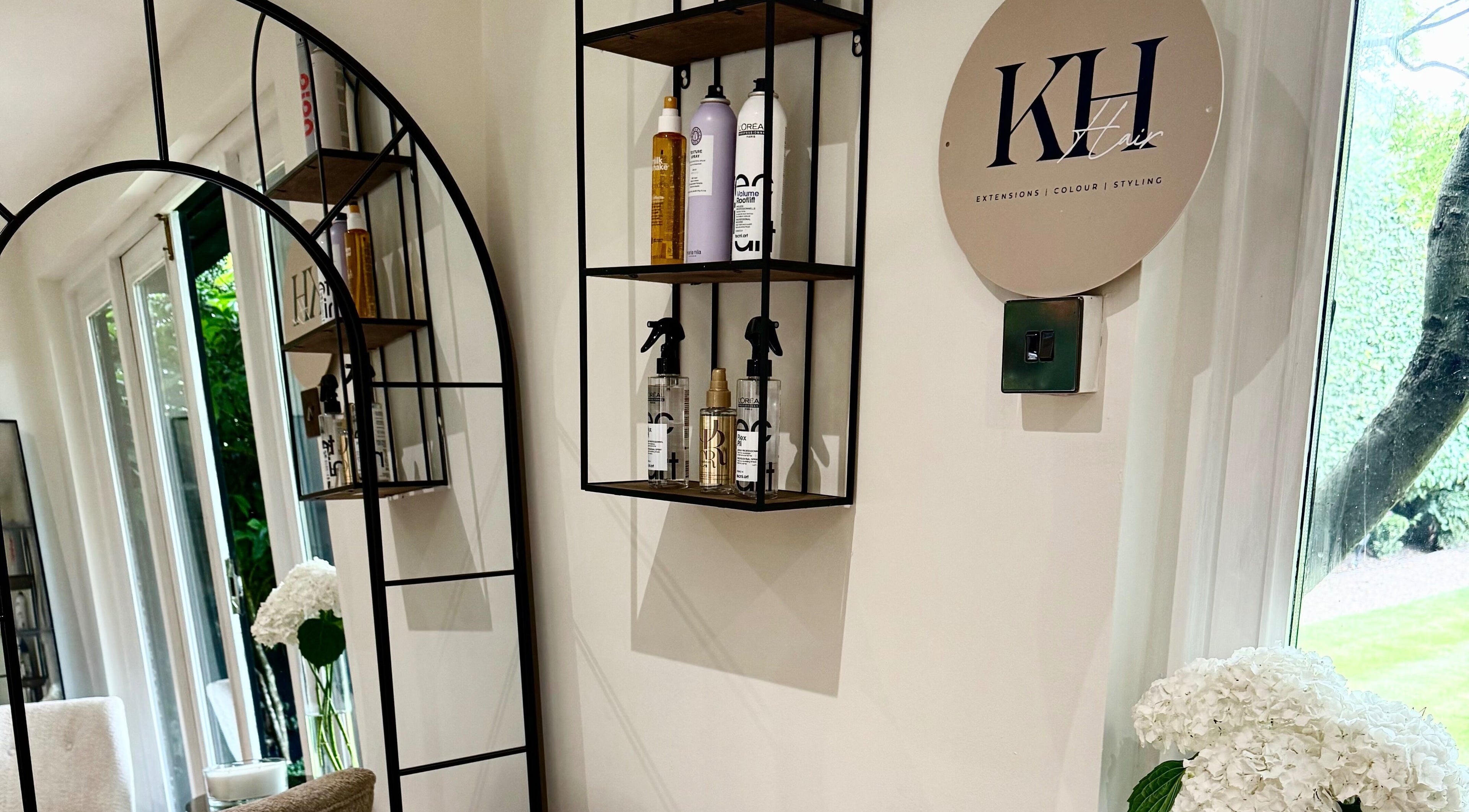 Elegant KH Hair salon interior with products on shelves in Edenbridge, England, GB.