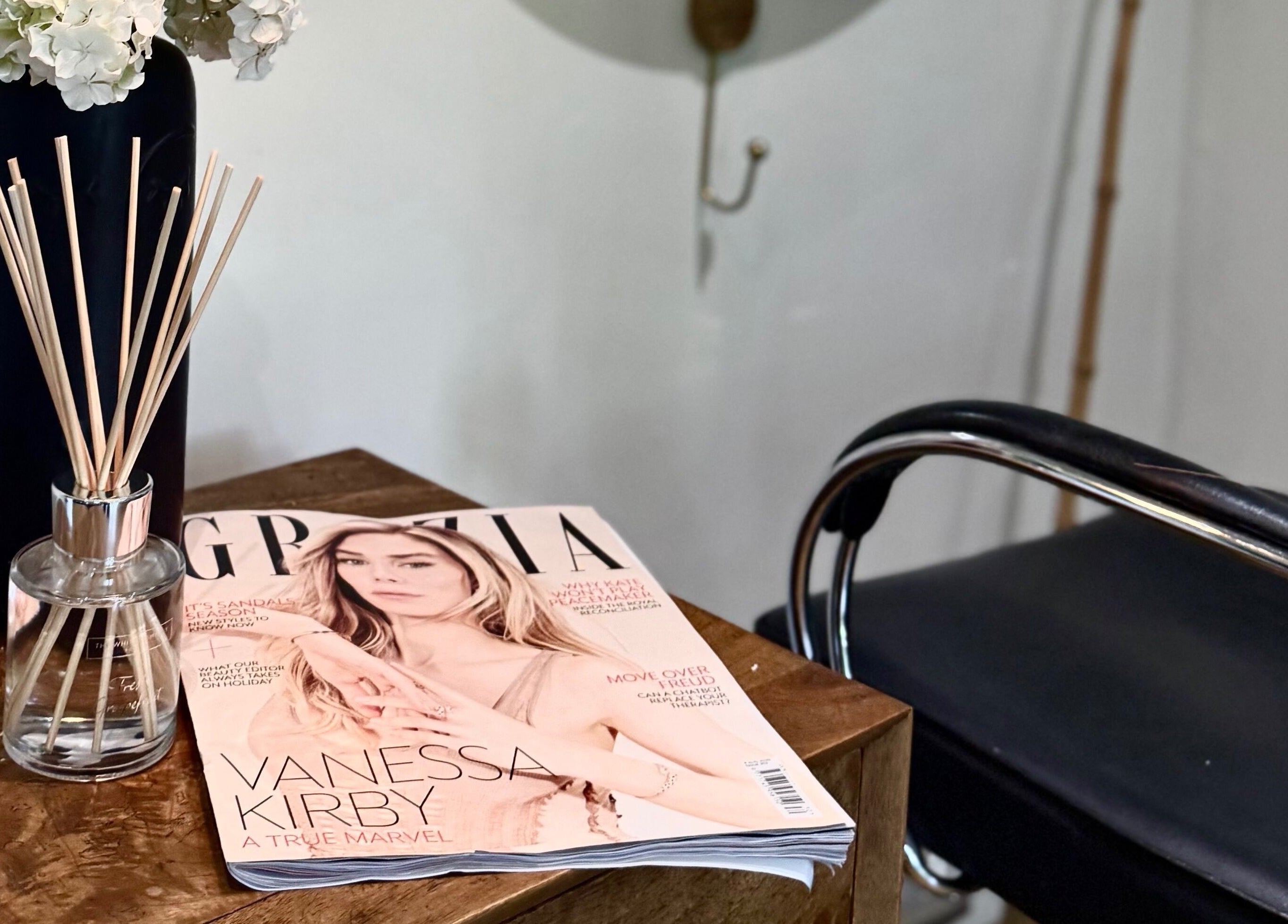Chic waiting area at KH Hair, Edenbridge, England, GB, showcasing stylish decor with magazine and floral vase.
