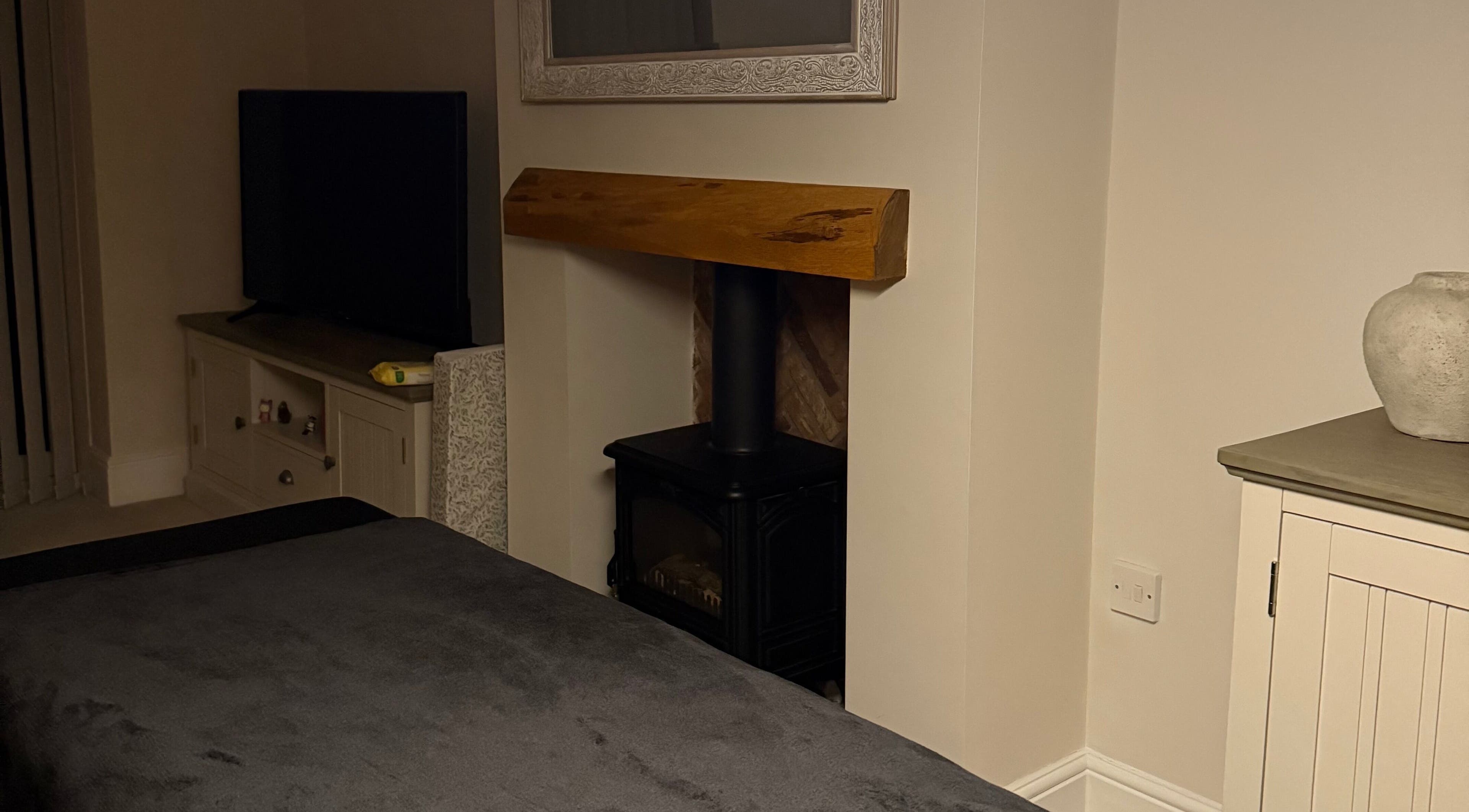 Relaxing interior of Naturabelle Aesthetics in Barlow, England featuring a cozy fireplace and decor.