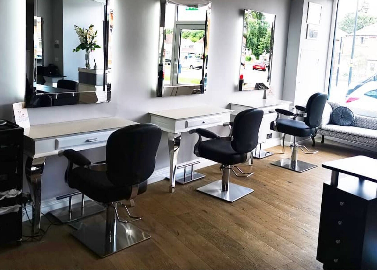 Spacious and chic interior of Glow Hair and Beauty Salon in Sutton Coldfield, England, GB with modern salon chairs.