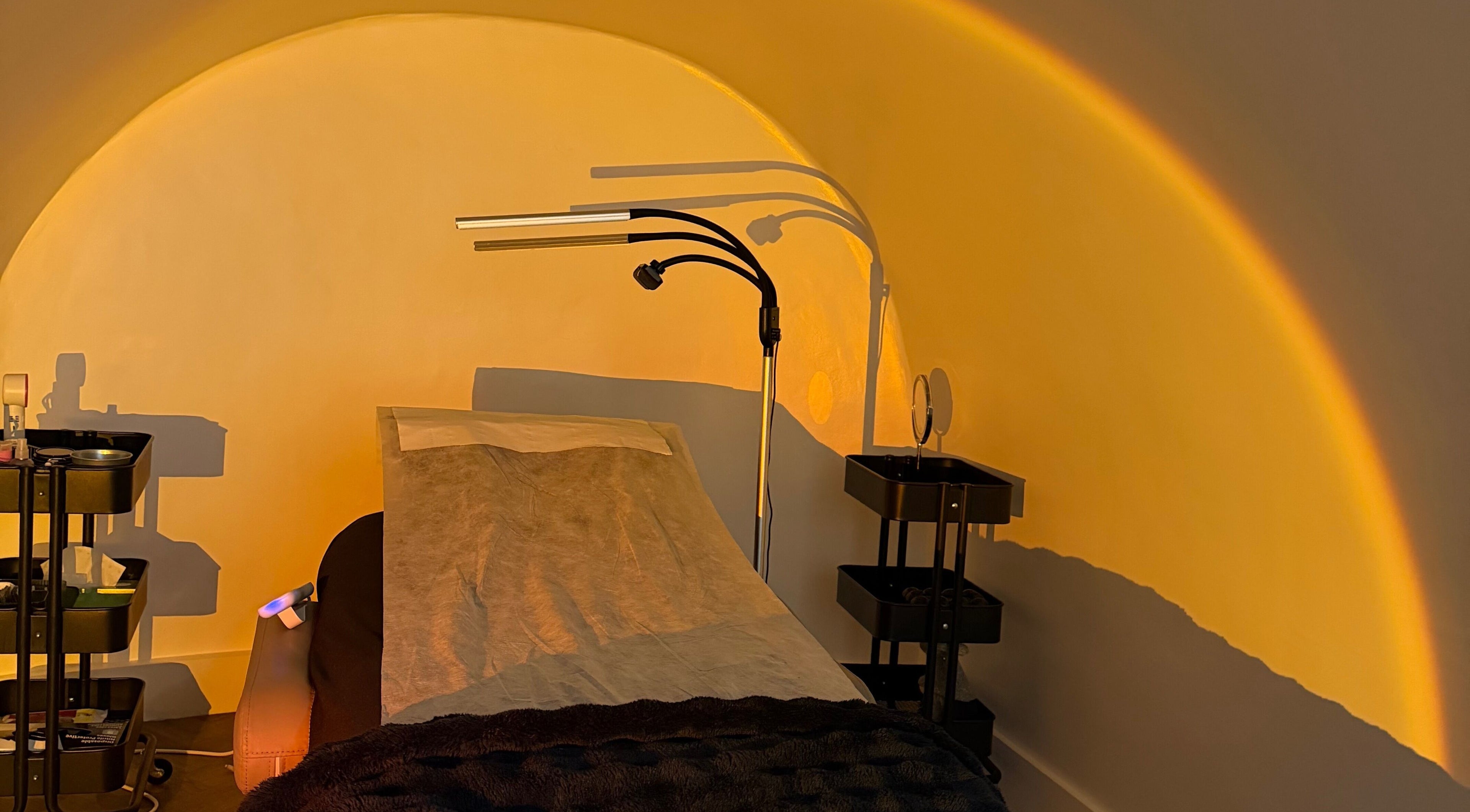 Cozy treatment room at Lolo Beauty | Beauty & Lash Salon London located in London, England, GB under warm lighting.