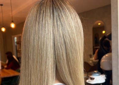 Straight blonde hair at Mary Hair, Sydney, New South Wales, AU, with elegant salon interior lighting.