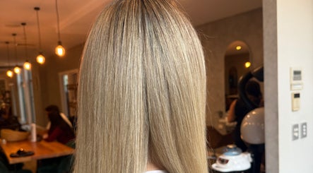 Straight blonde hair at Mary Hair, Sydney, New South Wales, AU, with elegant salon interior lighting.