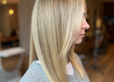 Side view of sleek blonde hair at Mary Hair, Sydney, New South Wales, AU. Expertly styled sheen and smoothness.