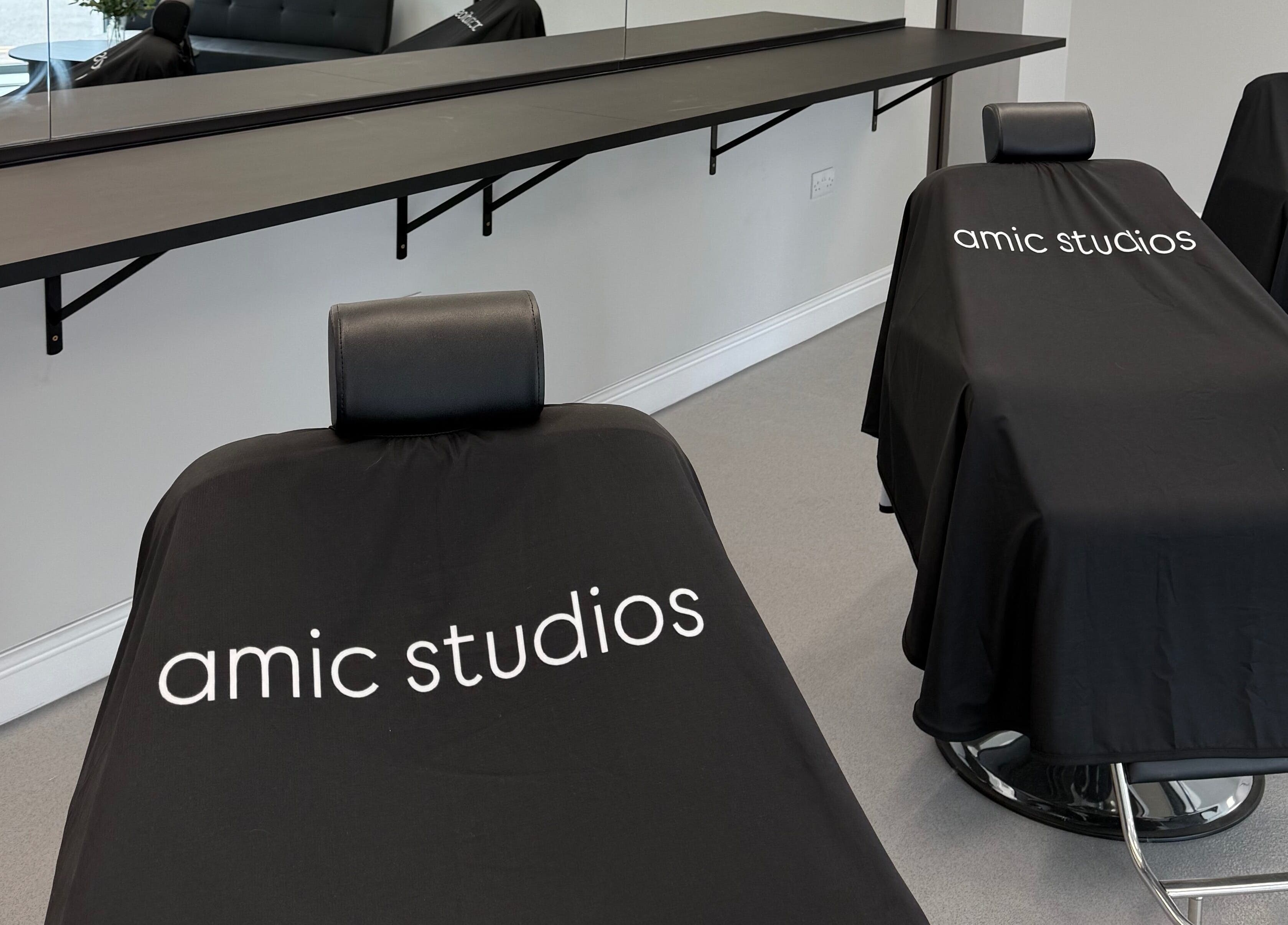 Modern salon chairs at Amic Studios, Birstall, England, GB, showcasing sleek design and comfort.