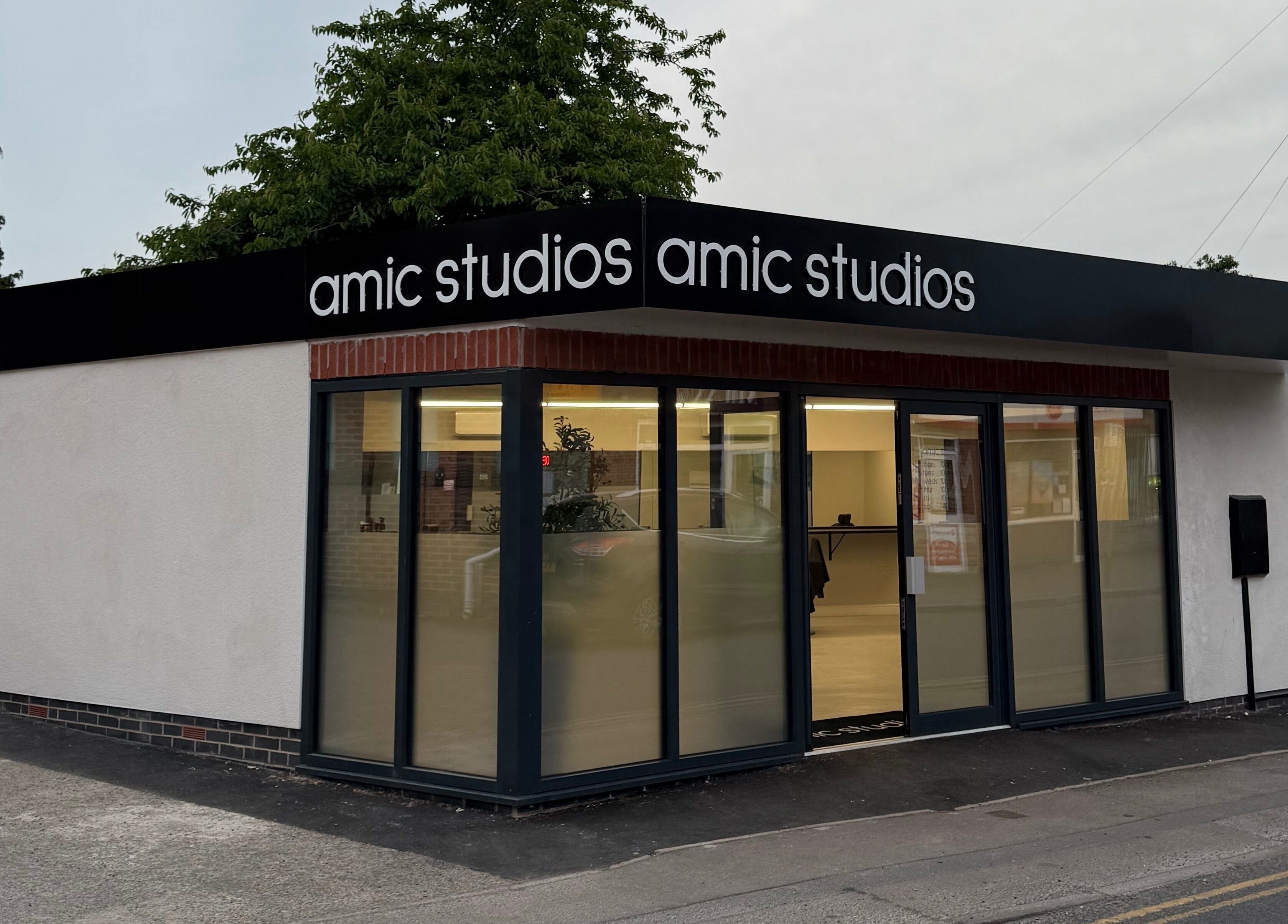 Modern facade of Amic Studios in Birstall, England, GB, showcasing sleek design and inviting atmosphere.