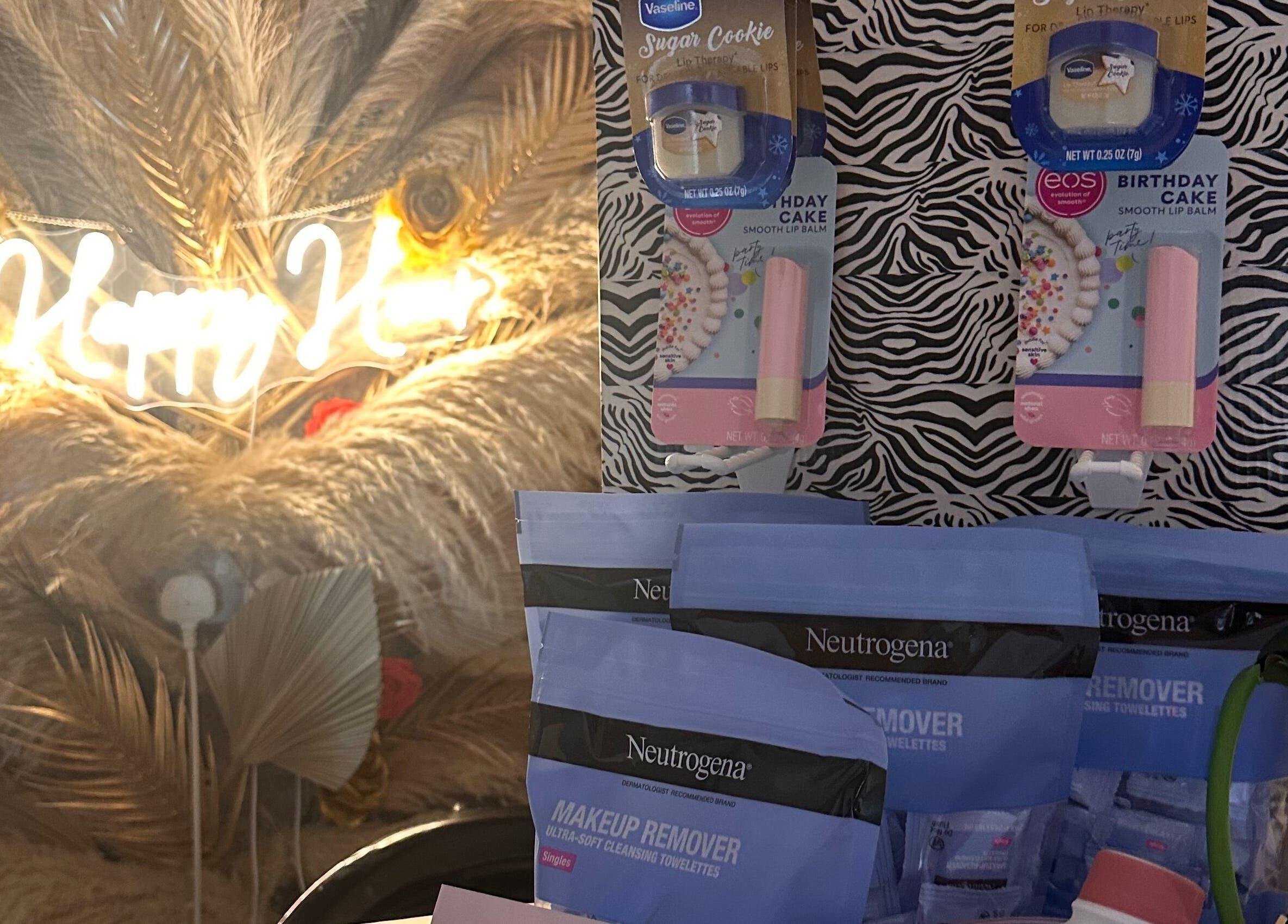 Beauty products display at The Beauty Bar by Chloe in Kirkcaldy, Scotland, GB with neon sign backdrop.