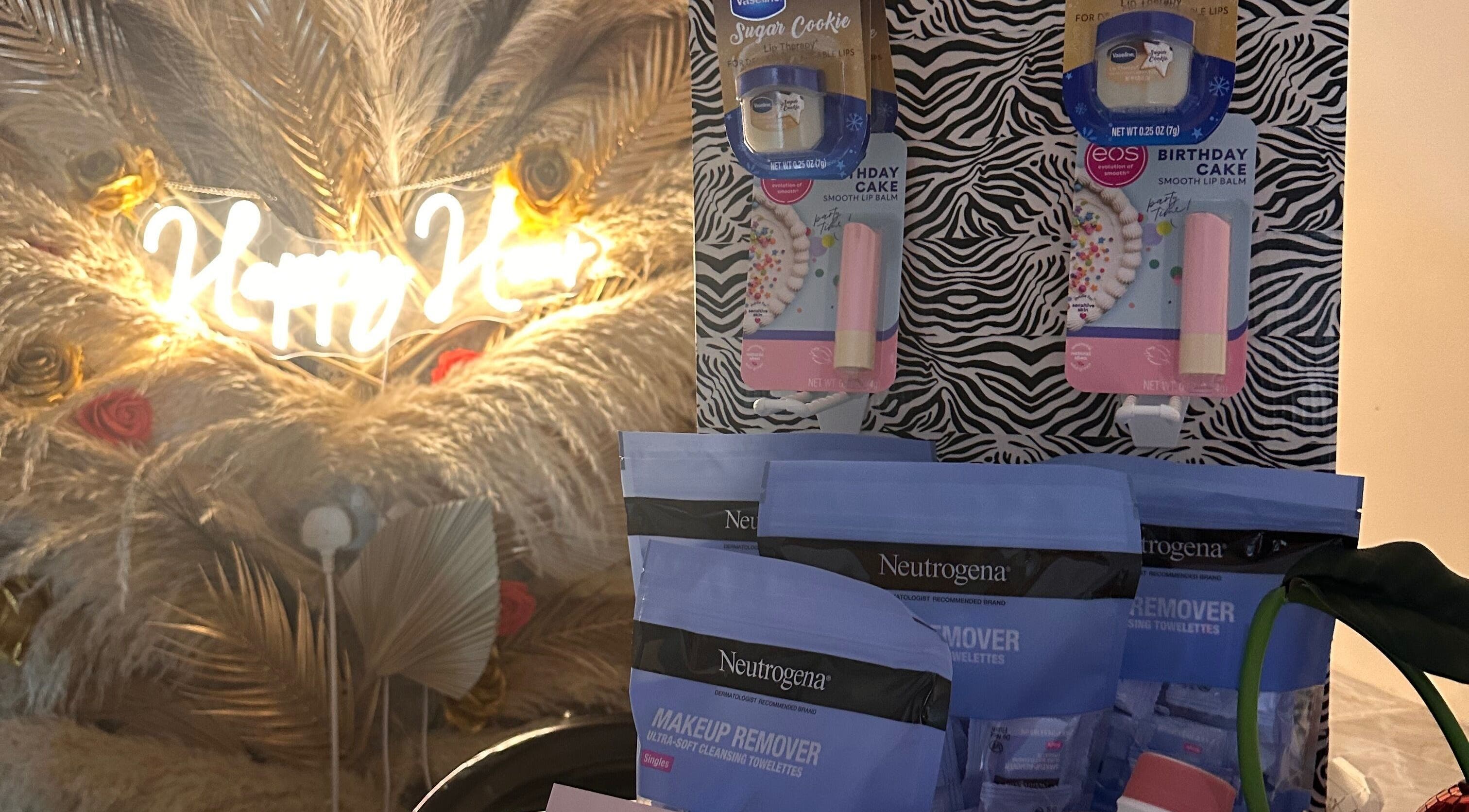 Beauty products display at The Beauty Bar by Chloe in Kirkcaldy, Scotland, GB with neon sign backdrop.