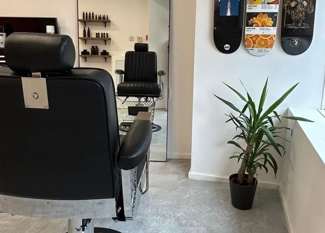 Luxury barber chair at Handsome Jacks Dennistoun in Glasgow, Scotland, GB, with stylish decor and natural light.