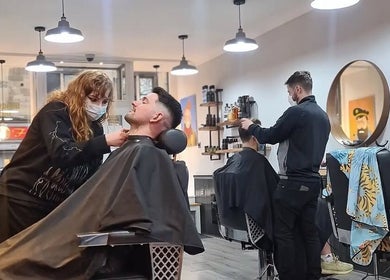 Barbers at Handsome Jacks Dennistoun in Glasgow, Scotland, GB offer grooming services in a modern setting.