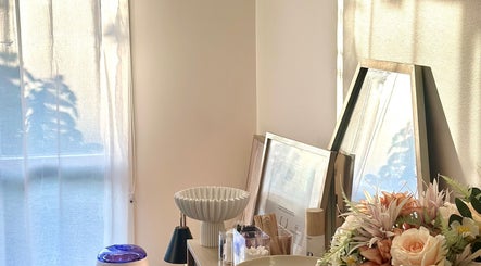 Elegant vanity setup at Barre & Co. Beauty, Melbourne, Victoria, AU with floral decor and mirror.