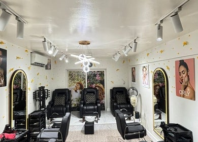 Chic interior of Aura & Elegance Beauty Salon in Dubai, AE featuring modern decor and comfortable seating.