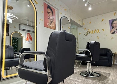 Modern and elegant salon interior at Aura & Elegance Beauty Salon in Dubai, AE featuring stylish seating and mirrors.