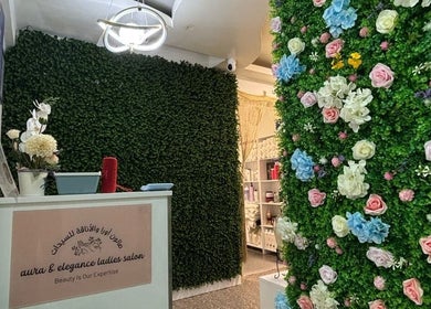 Reception area of Aura & Elegance Beauty Salon in Dubai, AE adorned with vibrant floral decor.