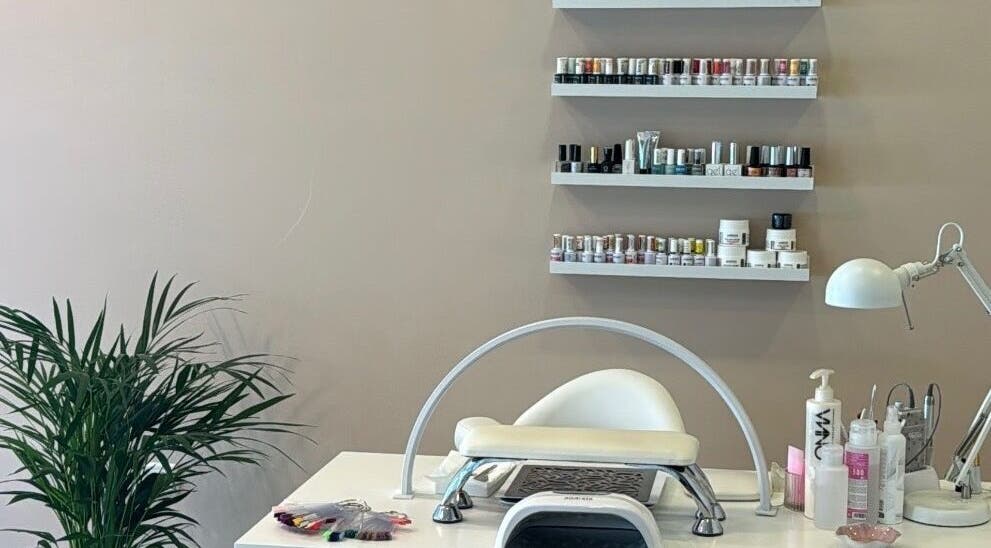Nail salon station at Beauty by Alannys in Estepona, Andalucía, ES with polish display and manicure tools.