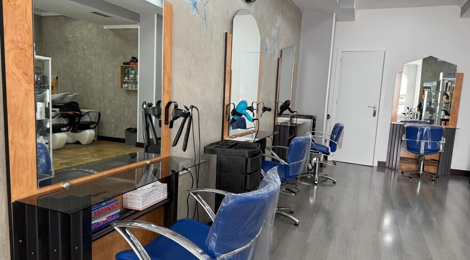 Vista interior de Karpe Peluquerías - Pozuelo en Pozuelo De Alarcón, Comunidad De Madrid, ES con modernos asientos azules.