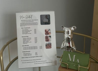 Mimis Aesthetics price menu display on a glass shelf in Shipley, England, GB with a silver decor bear.