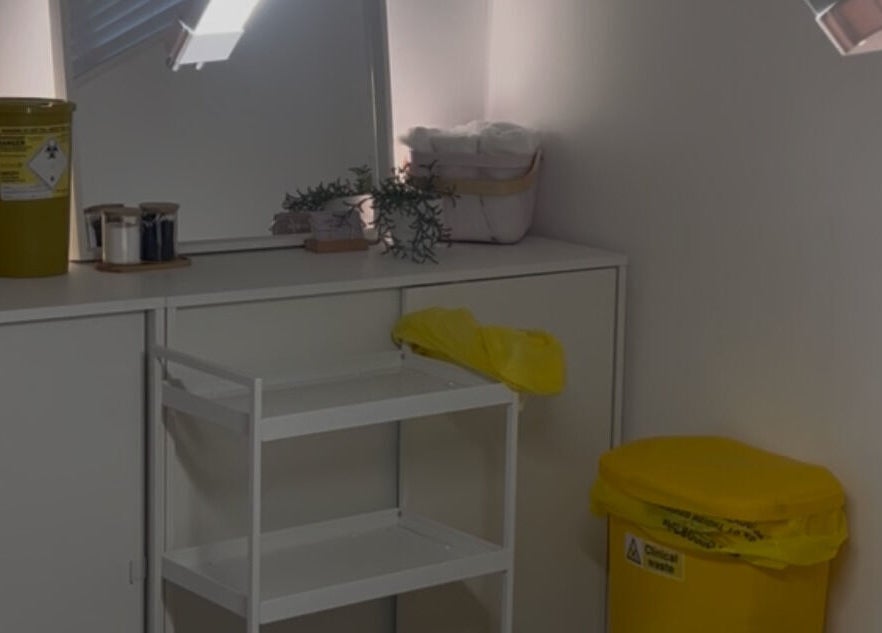 Treatment room at Mimis Aesthetics, Shipley, England, GB, featuring a stylish setup with organized shelves and decor.