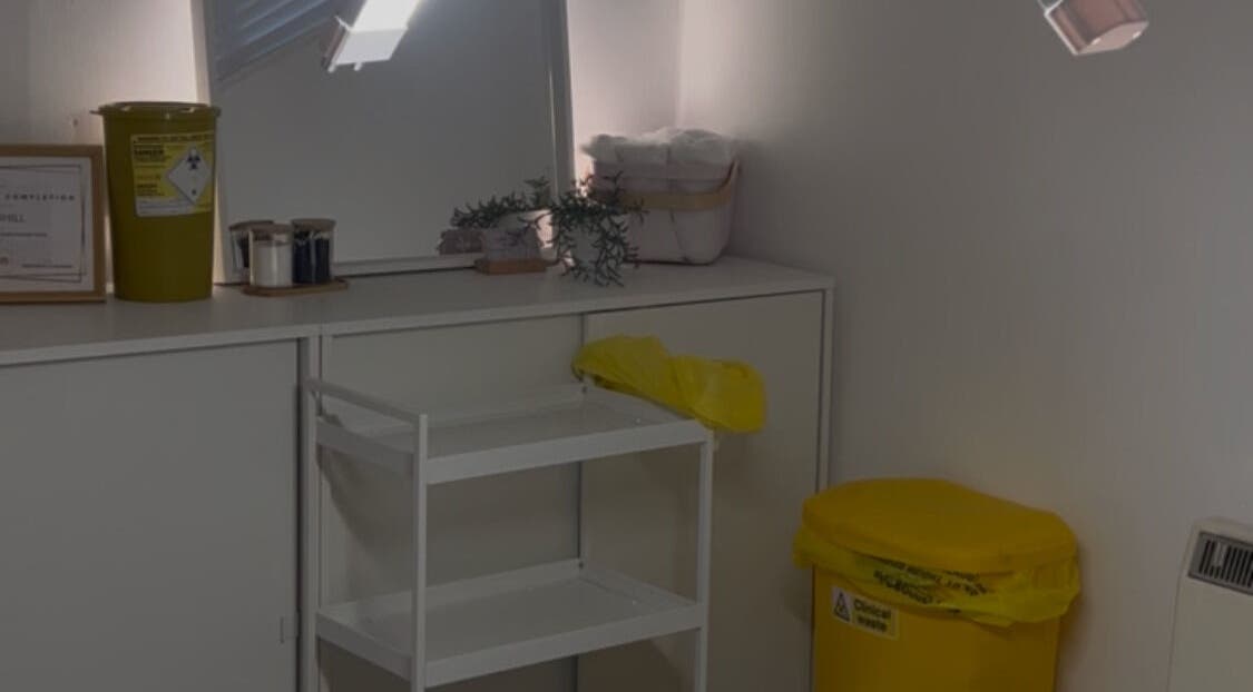 Treatment room at Mimis Aesthetics, Shipley, England, GB, featuring a stylish setup with organized shelves and decor.