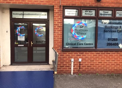 Front entrance of GP Healthcare Alliance in Hadleigh, England, GB. Clinical care center signage visible.