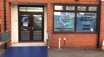 Front entrance of GP Healthcare Alliance in Hadleigh, England, GB. Clinical care center signage visible.