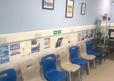 Seating area at GP Healthcare Alliance, Hadleigh, England, GB, showcasing modern chairs and health information.