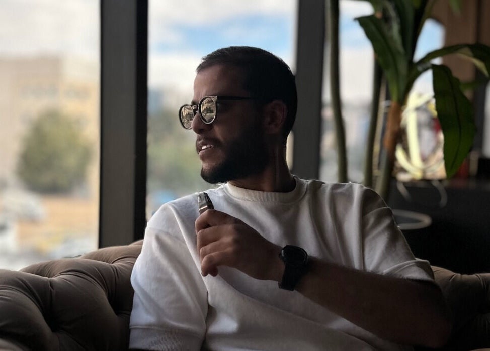 Man in sunglasses relaxes at Salon Blue Shadow, عمّان, محافظة العاصمة, JO, with stylish interior.