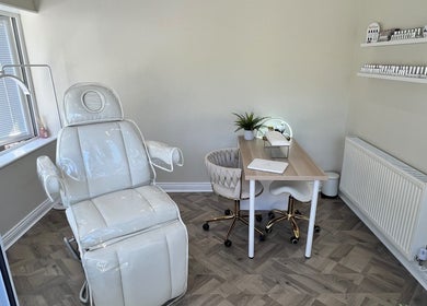 Elegant treatment room at Beauty and Massage by Stef, Higherford, England, GB featuring a plush chair and table.