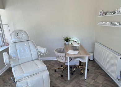 Relaxing treatment room at Beauty and Massage by Stef, Higherford, England, GB, with modern chair and desk.