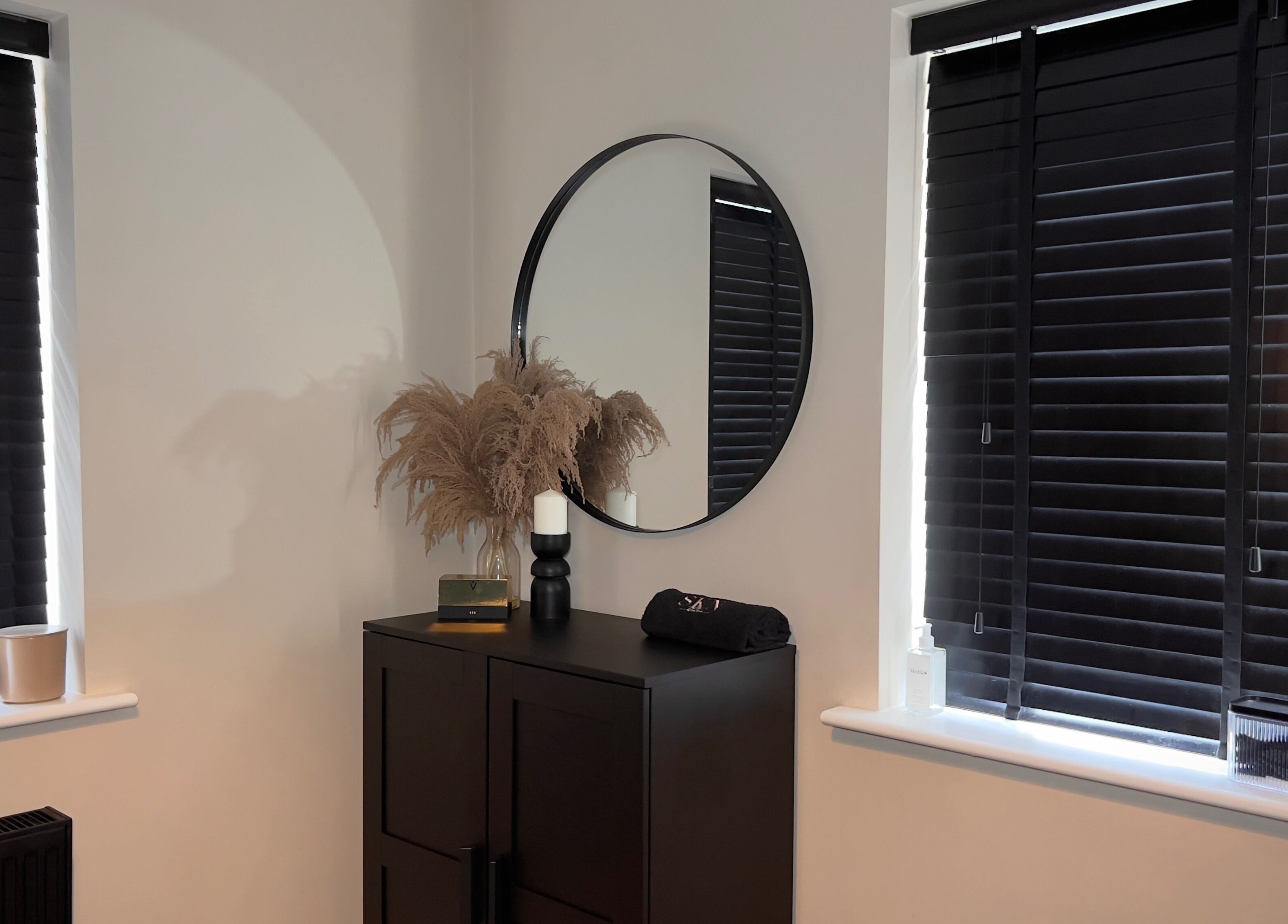 Elegant room at SKN by Scarlett - Warrington, featuring a round mirror and stylish decor in Warrington, England, GB.