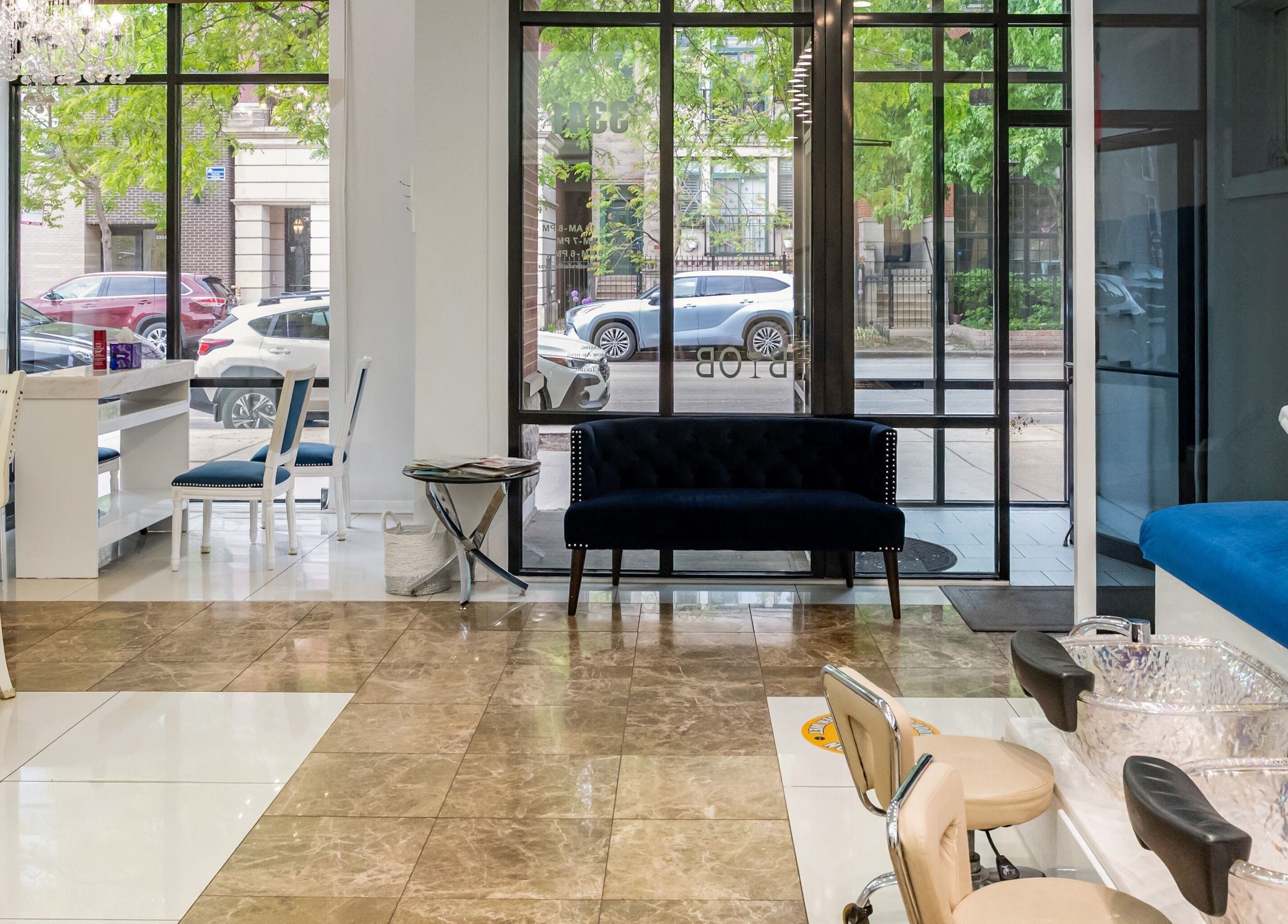 Elegant interior of Couture Nails and Waxing in Chicago, Illinois, US, featuring chic chairs and luxurious decor.